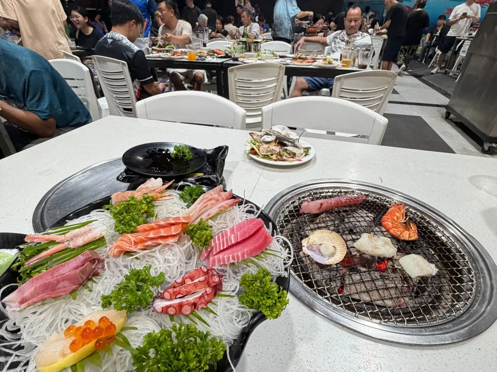 A Thai barbecue and seafood spread at a local night market in Thailand.